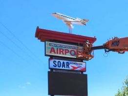 Final clean up  on the Greater Portsmouth Regional Airport sign built by the skilled artisans on Sun Sign Company's team