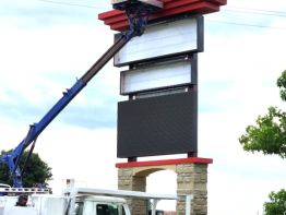 Sun Sign Company using its massive crane to lift the jet topper - Suny1 -  up to its perch on the roof