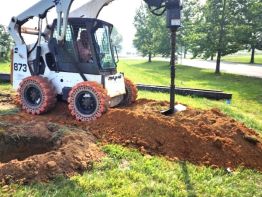 Auguring holes with precise placement 10.5 feet deep for the Greater Portsmouth Regional Airport sign